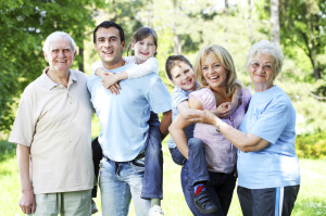 Extended happy family standing in the park.